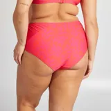 Braguita de bikini naranja con estampado de hojas fucsia.