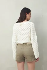 Short negro de tiro medio, con calce al cuerpo y dobladillos en los bordes.