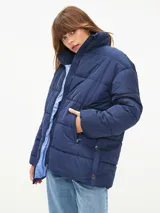 Campera puffer azul marino con cuello alto y cierre frontal.