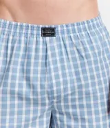 Calzoncillo boxer de tela tricolina con estampa de cuadros azules y blancos, cintura elástica con logo de la marca.