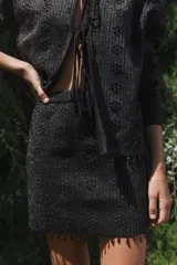 Minifalda negra tejida con lurex y mostacillas en el ruedo.