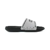Chancletas Puma Royalcat Comfort 2, con base negra y tira ancha blanca con logo de la marca en negro.