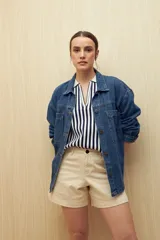 Short negro de tiro medio y corte clásico, con bolsillos delanteros y traseros. Confeccionado en algodón con elastano.