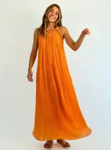 Vestido largo color naranja, de corte recto y escote halter con detalle de volados.