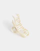 Broche para el pelo color crema con forma de moño.