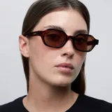Lentes de sol unisex con montura ovalada de carey y lentes marrones polarizadas. Fabricados con materiales bio-based G850 y patillas de propionato de celulosa. Cuentan con protección UV400 y recubrimiento antiscratch y superhydrophobic.