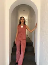 Conjunto de chaleco y pantalón de vestir color ladrillo con rayas verticales blancas.