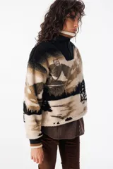 Buzo de polar con cuello alto y cierre frontal parcial. Diseño con estampado de montañas en tonos beige, marrón y negro.