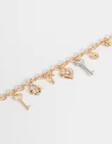 Collar corto con cadena de eslabones dorados y multidijes de corazones, llaves y moño de metal plateado y dorado.