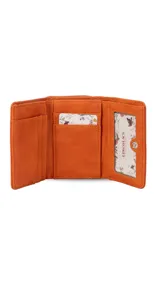 Billetera corta de símil cuero color beige claro, con cierre de broche a presión en la solapa principal. Presenta múltiples compartimentos internos para tarjetas y billetes, y un bolsillo exterior con cierre en la parte posterior. Lleva una placa metálica con el logo de la marca.