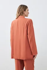 Blazer color ladrillo de lyocell con solapas, bolsillos delanteros y corte recto.