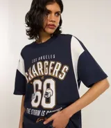Remera deportiva oversize de algodón, color azul marino con mangas cortas blancas. Estampa frontal con el nombre "Los Angeles Chargers", el número "60" y el logo de la NFL.