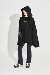Buzo oversize negro de frisa esmerilada con capucha amplia, bolsillos laterales, terminaciones de puño y ruedo con rib, doble cordón con terminal termocontraíble y estampa serigrafiada en frente, manga y espalda con la palabra 'RENÉE'.