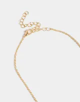 Collar corto dorado con cadena de eslabones y dije doble de corazones, uno liso y otro con incrustaciones de perlas.