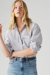 Camisa de manga larga a rayas verticales blancas, negras y violetas, con bolsillo en el pecho.