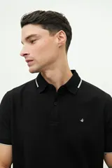 Remera polo verde militar con textura, corte regular, cuello clásico con detalles en azul marino y logo estampado en el pecho.