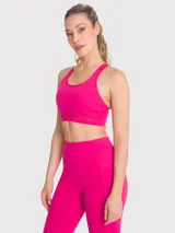 Top deportivo fucsia con soporte medio, almohadillas removibles, tirantes finos con detalle de encaje y espalda con tirante grueso central.