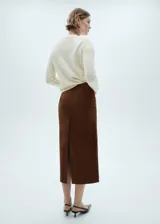 Sweater color crema de tejido de punto grueso con cuello redondo y mangas largas.