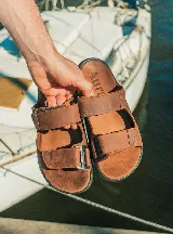 Sandalias Aura de cuero color marrón, con tiras ajustables con velcro y plantilla acolchada.