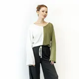 Blusa de mangas largas, con corte holgado y escote redondo. Presenta un diseño color block, con la mitad izquierda en color blanco y la mitad derecha en color verde oliva.