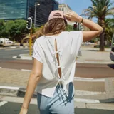 Camiseta blanca de manga corta con espalda abierta y lazos.