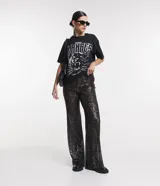Pantalón largo de lentejuelas negras metalizadas con forro y cintura elástica.