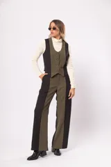 Pantalón fluido de tiro alto en negro y verde, con bolsillos delanteros y traseros, cierre frontal con cremallera y botón.