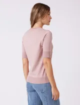 Buzo de punto fino color azul marino, con cuello redondo y mangas cortas.