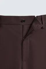 Pantalón de vestir color marrón oscuro, de corte recto, con bolsillos laterales y traseros de doble vivo. Se ajusta a la cintura con cierre de cremallera y botón.