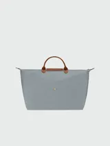 Bolso de viaje plegable con cierre y asa corta, de diseño clásico y color negro.