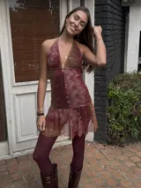 Vestido corto con lentejuelas color verde esmeralda, escote en V profundo y espalda descubierta.