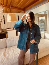 Campera tipo trench de jean con corte oversized y cinturón. Presenta espalda y cuello de cuero ovino.