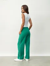 Pantalón blanco de corte ancho con una fina línea negra vertical en los laterales.