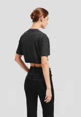 Remera cropped negra de algodón con estampado de un trozo de torta con cereza.