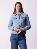Campera de jean celeste, marca Baccini, con cuello solapa, bolsillos delanteros y cierre frontal con botones metálicos.
