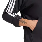 Buzo con capucha Adidas, color negro, con bolsillo canguro frontal y las tres franjas blancas características de la marca a lo largo de las mangas. Presenta el logo Badge of Sport en blanco en el pecho.
