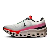 Championes de running On Cloudmonster 2, color blanco con detalles en negro, rojo y rosa.