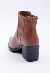 Bota negra de caña baja con pespuntes, tacón medio y diseño clásico.