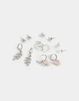 Set de seis pares de aros dorados con diferentes diseños: perlas, mariposas, corazones y hojas.