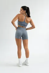 Top deportivo negro con efecto lavado, breteles finos y espalda deportiva.