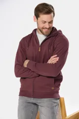 Canguro con cierre y capucha color bordó, confeccionado en felpa de algodón y poliéster.