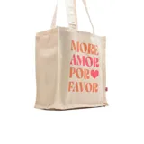 Bolso tipo tote bag de tela color crudo con asas cortas y estampado con la frase "More Amor Por Favor" en letras color naranja y rosa.
