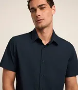 Camisa negra de manga corta, corte slim, con cuello inglés y abotonadura frontal. Confeccionada en viscosa con fibra de bambú.