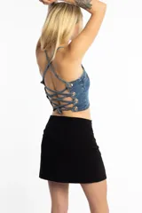 Top corto de jean con breteles finos y espalda con tiras cruzadas y ojales metálicos.