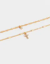 Collar corto multicadena bañado en oro con dije de cruz y dije de cristal.