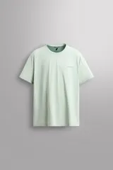 Camiseta deportiva verde claro confeccionada en tejido técnico, ligero y elástico en cuatro direcciones. Tiene cuello redondo, manga corta, zonas con estructura perforada y logo estampado.