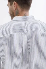 Camisa de rayas en tonos claros, con cierre frontal de botones y corte clásico.