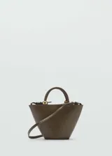 Bolso color verde oliva con forma trapezoidal, efecto piel, asa de mano y asa larga desmontable.