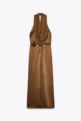 Vestido midi color marrón de satén, con cuello halter fluido y espalda descubierta. Presenta un nudo en la parte delantera, abertura frontal y cierre trasero con cremallera oculta.