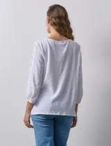 Blusa blanca texturada marca Ruby Rd, con escote redondo y mangas 3/4 con puño elastizado y apliques de broderie. Confeccionada en poliéster y elastano.